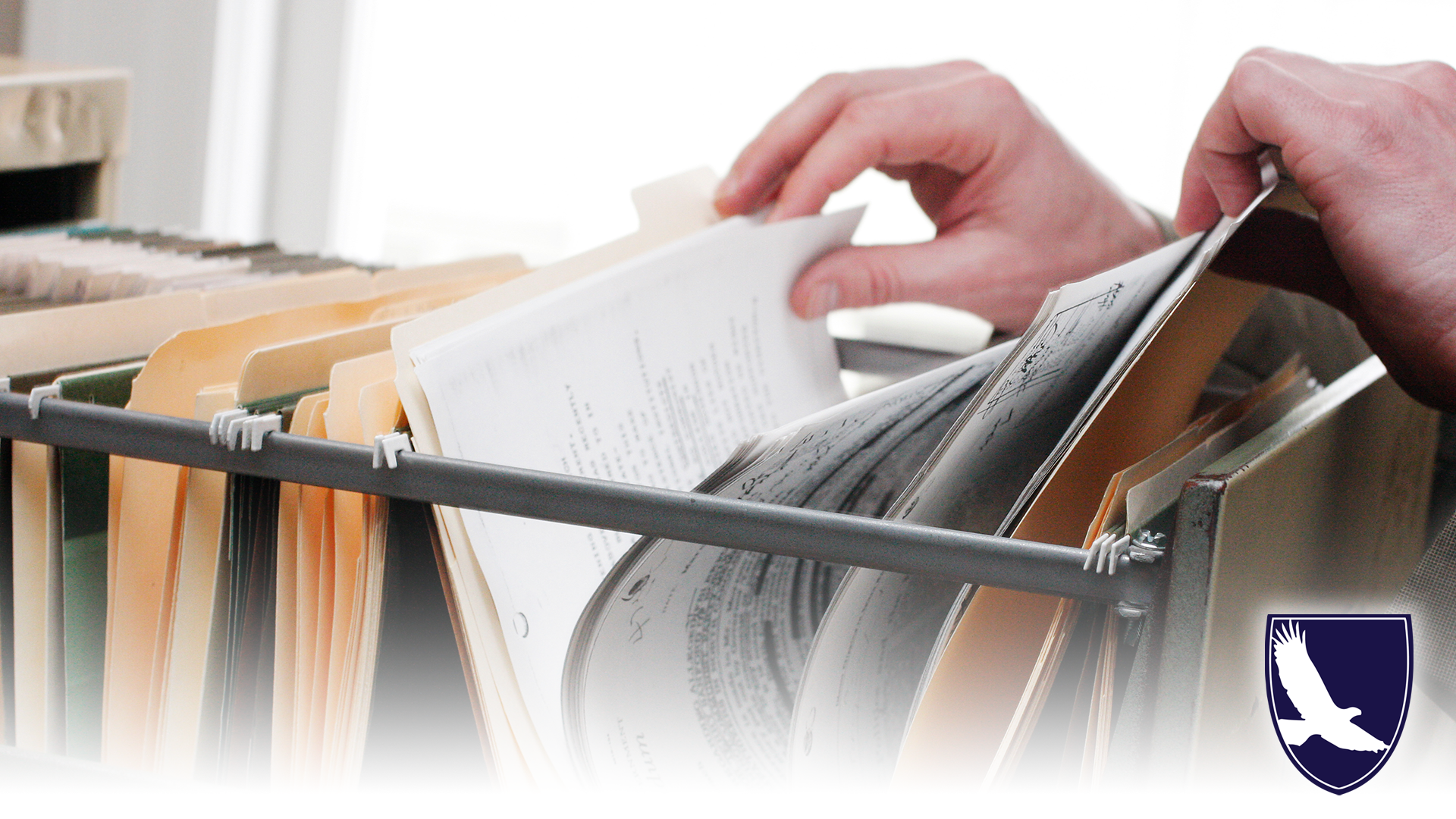 Hands going through files in a cabinet